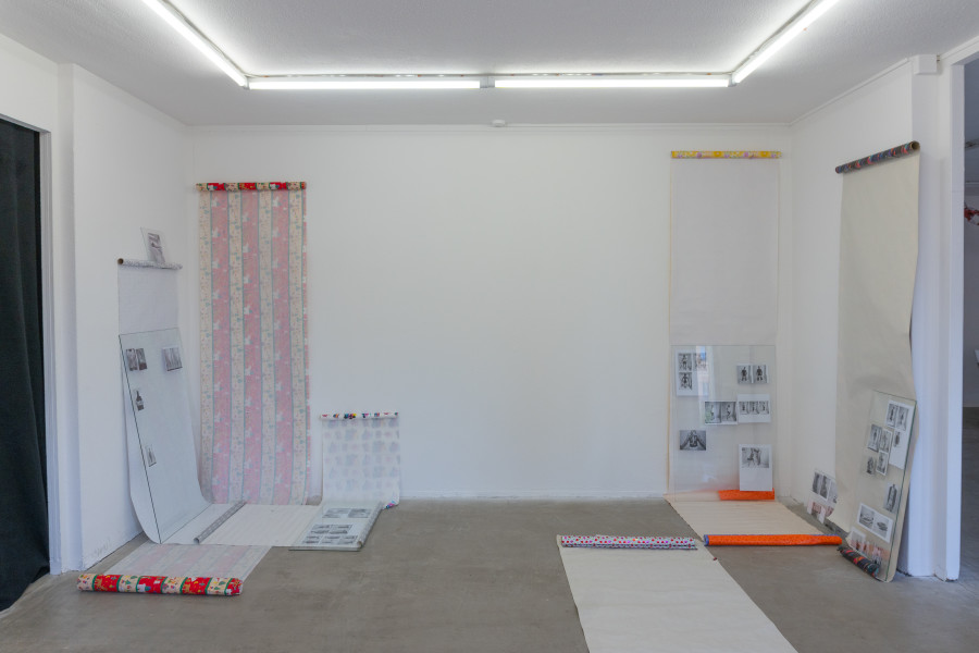 Exhibition view, Sven Gex, celebratory, Halmet, Zürich, 2025. Sven Gex, celebratory, 2025, gift wrapping paper, nails, glass, printed images from the ‚character fitting‘ series 2021-ongoing