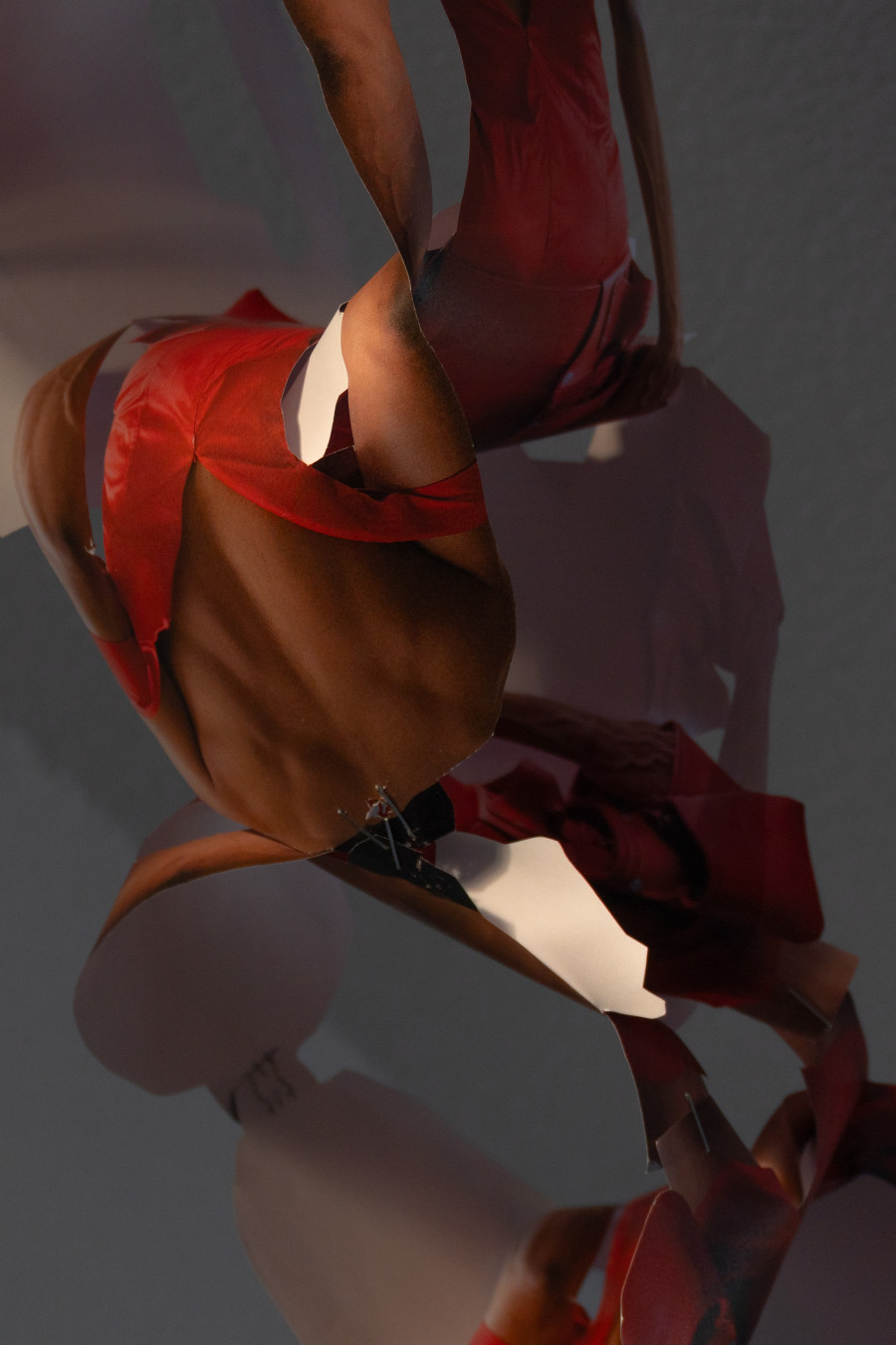 Exhibition view, Sven Gex, celebratory, Halmet, Zürich, 2025. Sven Gex, garland for ‚celebratory‘ (maid-of-all-work character), 2025, hand cut printed pictures, staples