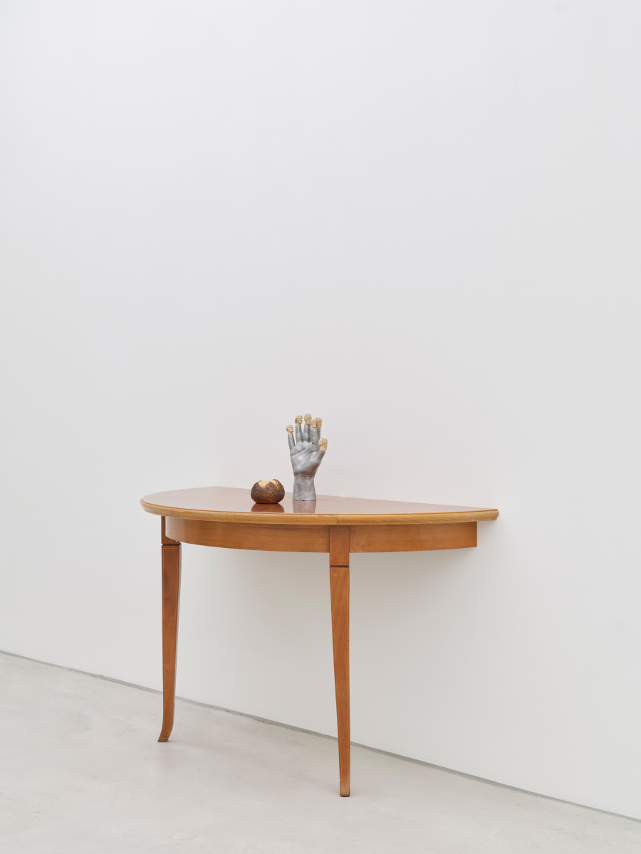 Young-jun Tak, Seem More, 2024, Lime wood, aluminum, half of a table, faux bread roll, beeswax, 104 × 125 × 62.5 cm, Version 1/3 + 1 artist’s proof. Photo credit: Conradin Frei