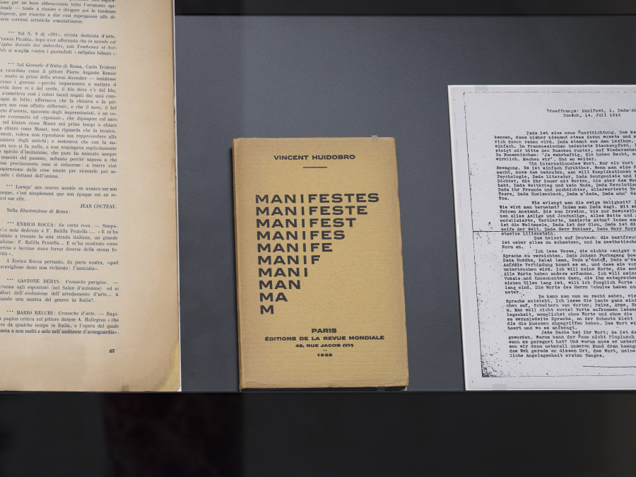 Exhibition view «Poetry for Revolutions», Cabaret Voltaire 2023; Dada showcase with changing exhibits from the collection of the Kunsthaus Zürich: Magazine Procellaria, number 5, 1920, Mantova, pp.66-67; Vincent Huidobro, Manifestes, Manifeste, Manifest, Manifest, Manifeste, Manif, Mani, Man Ma, M, 1925, Paris; Hugo Ball, Eröffnungs-Manifest (Opening Manifesto), 1916, Zurich (facsimile). Photo: Cedric Mussano.