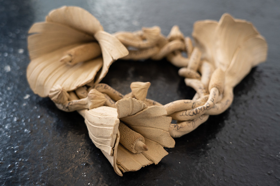 Ayla Dymterko, Vestige Vinok I, with hollyhocks, 2022. Stoneware ceramic with charcoal glaze. 10 x 38 x 28 cm. Unique. Photographer: Marcel Scheible. Courtesy of the artist and VITRINE London/Basel