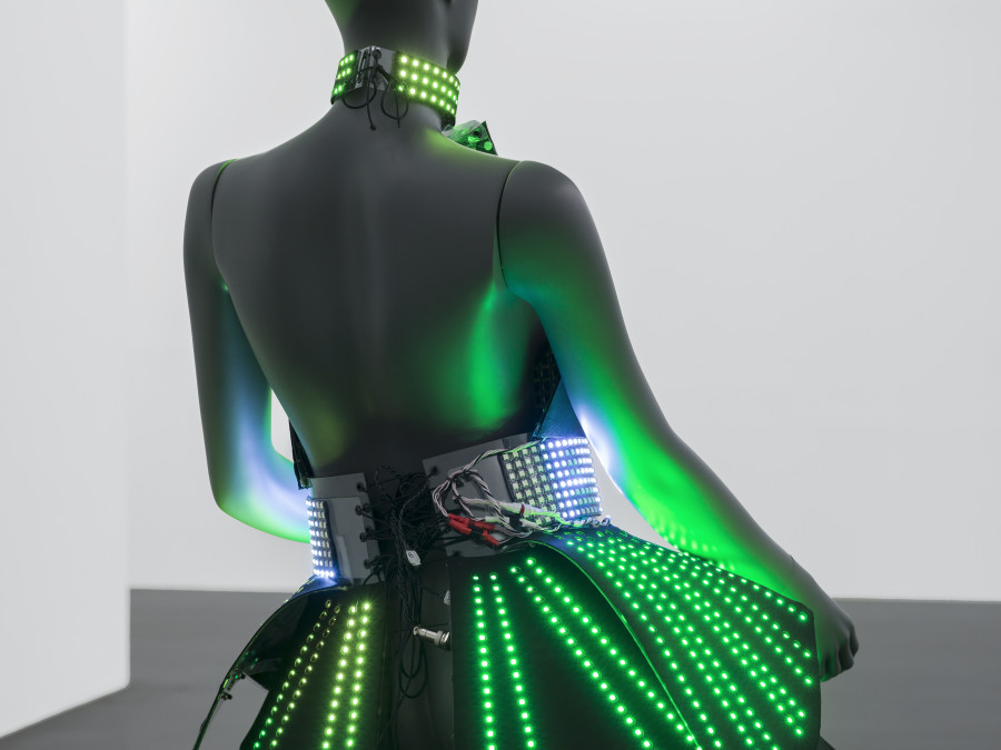 Puppies Puppies (Jade Guanaro Kuriki-Olivo), Electric Dress (Atsuko Tanaka), 2023, LED-dress made from textile and plastic, draped on mannequin, 12 lithium-ion batteries in cases in textile pockets, Madrix programmed micro SD-card, performance (optional), Dress 81 × 66 × 63 cm