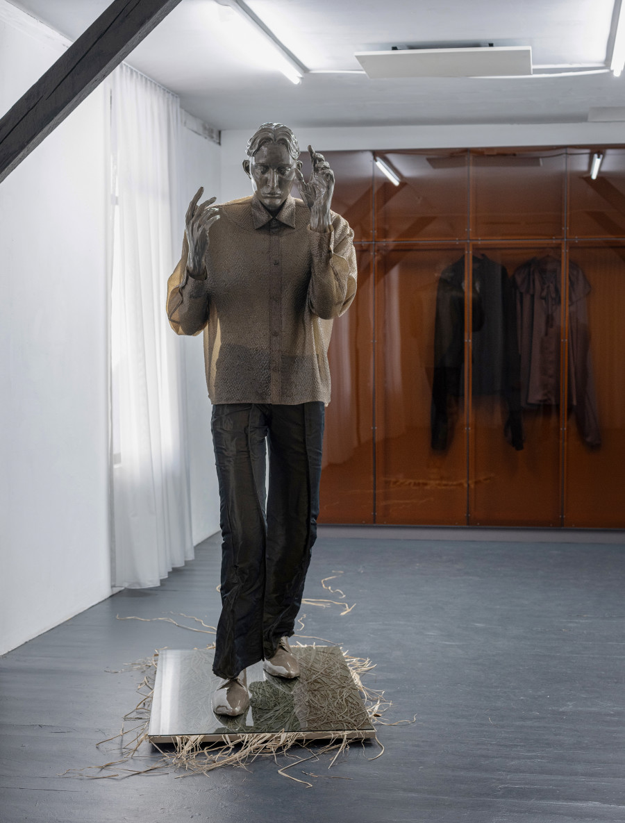 Front: Pascale Birchler, Still Untitled, 2024, iron, modelling clay, glaze, pigments, textile, grass, wood and glass, ca. 215 × 85 × 200 cm. Back: Pascale Birchler, Still Untitled, 2024, wood, acrylic glass, textile,  260 × 250 × 40 cm Photo by Bon Wongwannawat. Courtesy of the artist and Last Tango