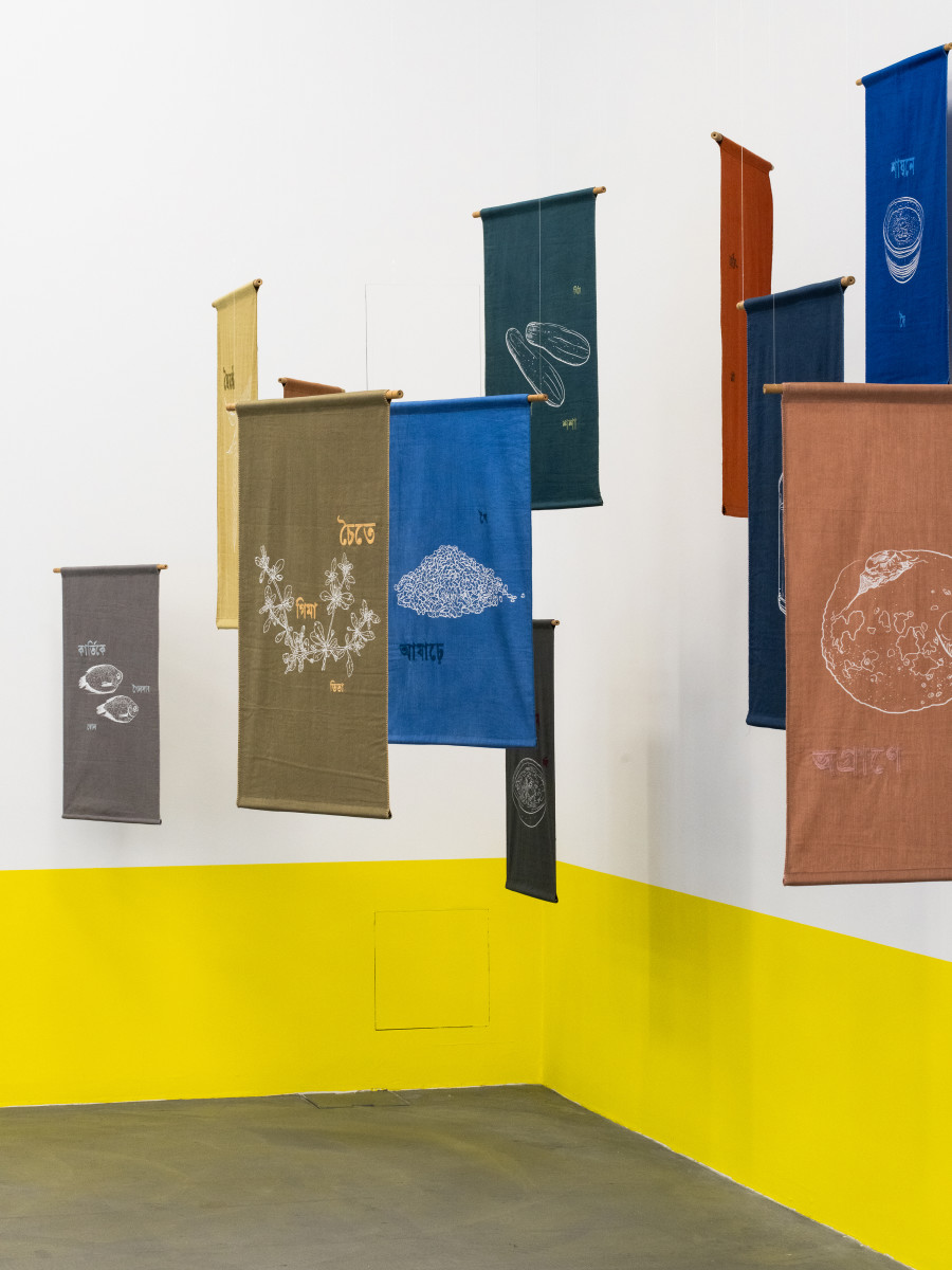 Munem Wasif, Song of Seasons – An Ecological Calendar, 2023 – Ongoing, Natural dye textile, drawing from photographs, silkscreen print, hand-stitched text with wooden and steel hanging system, Courtesy of Munem Wasif and Project 88. Installation view Migros Museum für Gegenwartskunst, Photo: Studio Stucky