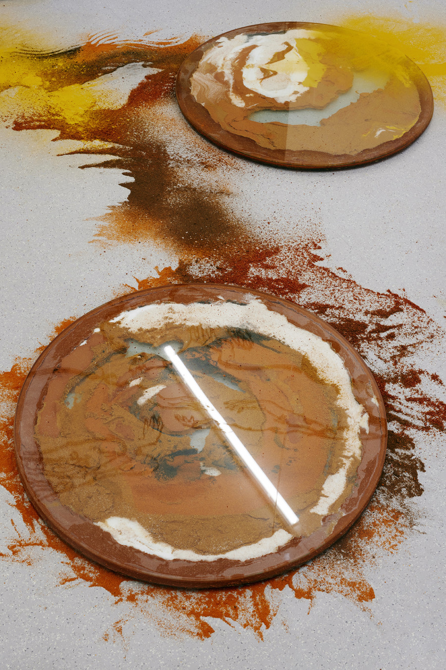 Monia Ben Hamouda, The Luncay of Lunar Sightings (Hourglasses VIII & IX), 2022, Glass, chilli pigmented silicon, spices, 80 x 80 x 3.5 cm, each. Installation view from the solo show The Eye, the Hands, the Lunacy of Lunar Sightings, curated by Anissa Touati, jevouspropose, Zurich, 2022. Courtesy of the artist and ChertLüdde, Berlin, photo: Hannes Heinzer