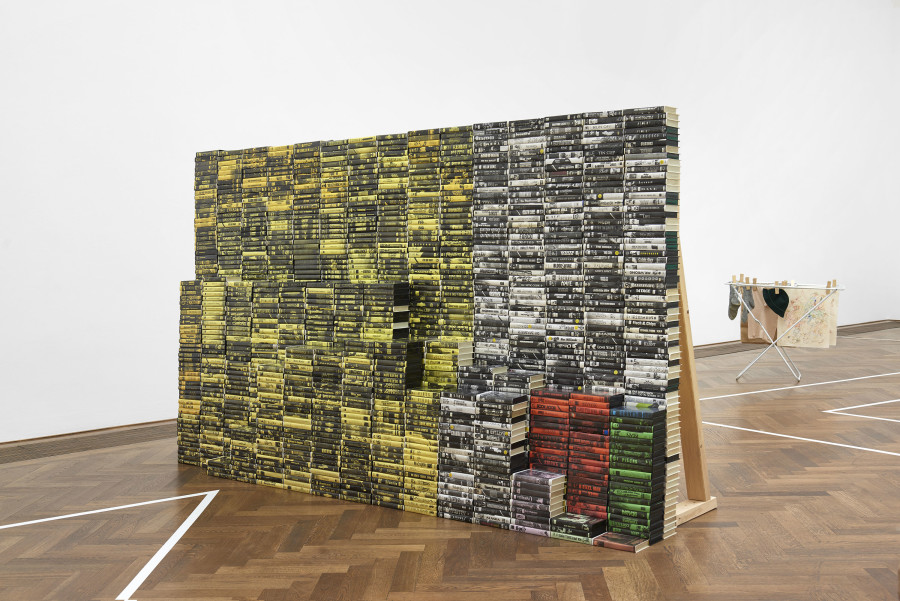 Installation view, Situation 1 und andere, Kunsthalle Basel, 2020, view on Mitchell Anderson, Personal Copy, 2018 (front), Isadora Vogt, Kleiderständer 1, 2020 (back). Photo: Philipp Hänger / Kunsthalle Basel