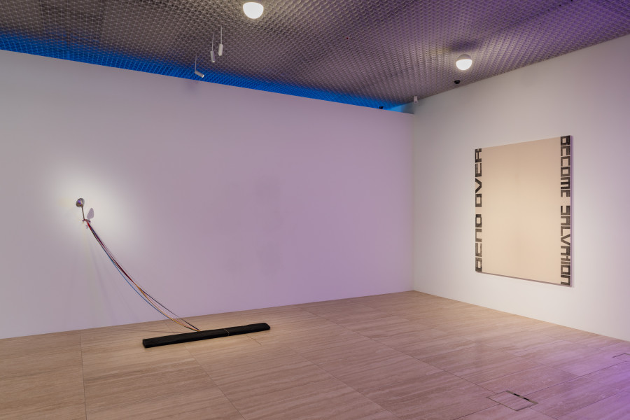 Left: Vittoria Santoro, Memories of a Bird (Rear-View Mirror), II, 2020, Bronze casting of a Wood Plank, Silk ribbons, Hemp string, Vintage rear-view Mirror mounted n wall, Pencil in wall, ca. 170 x 179 x 95 cm.  Right: Marlene McCarty, Untitled (Bend Over Become Salvation), 1993, Heat Transfer on Canvas, 198 x 152 cm Private collection, Switzerland. Photo: Kilian Bannwart