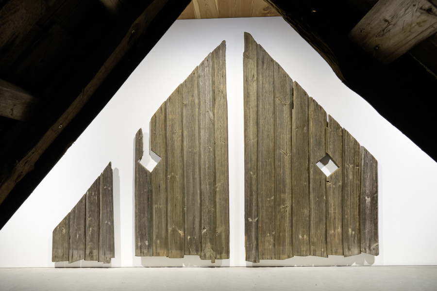 Exhibition view, Augustas Serapinas, Pediment from an Unknown House, 2022, reclaimed wood, 222 x 330 x 5.5 cm. Photo: Ralph Feiner, Courtesy of the artist and Galerie Tschudi