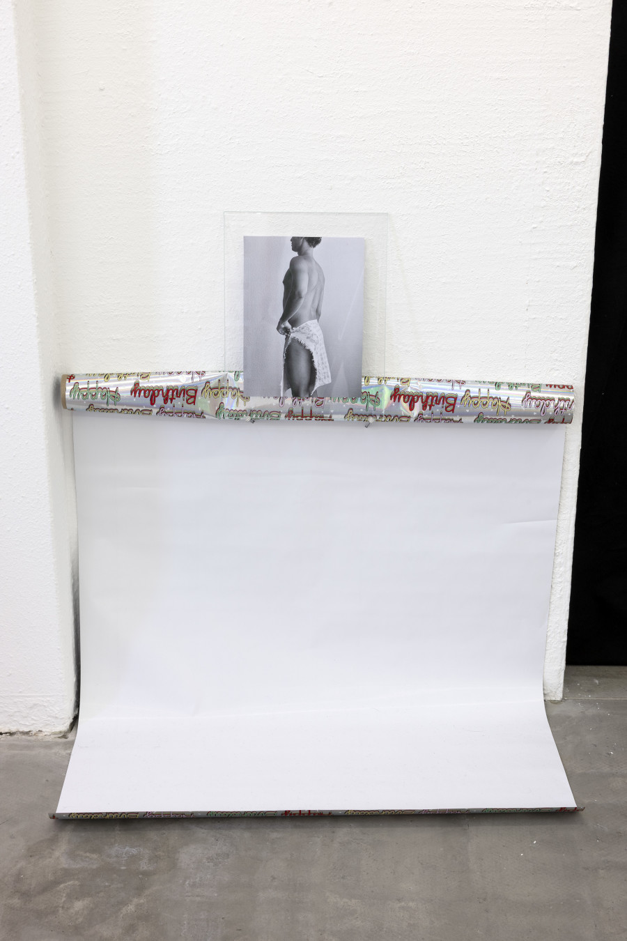 Exhibition view, Sven Gex, celebratory, Halmet, Zürich, 2025. Sven Gex, celebratory, 2025, gift wrapping paper, nails, glass, printed images from the ‚character fitting‘ series 2021-ongoing
