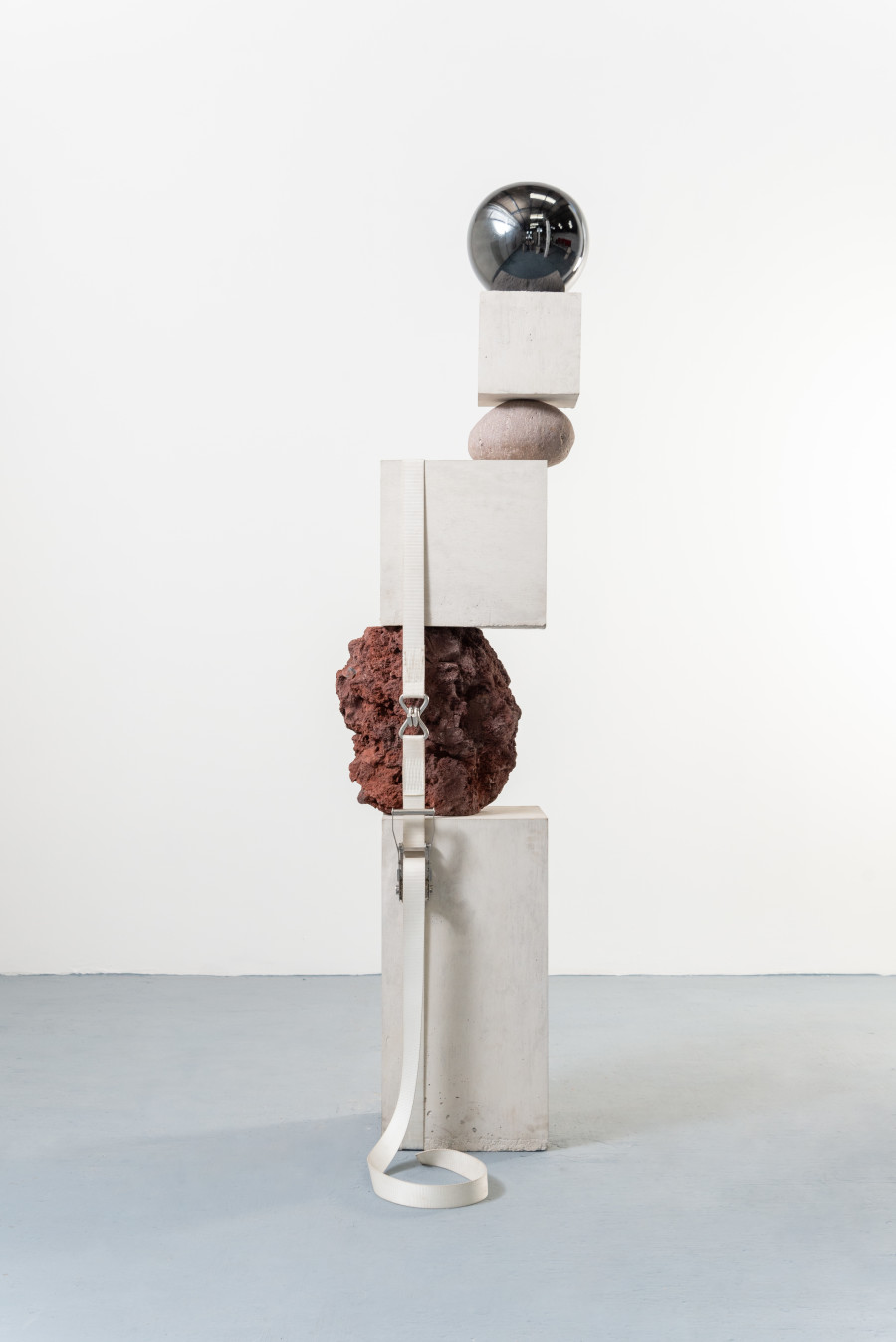 Jose Dávila, Fundamental concern, 2022, Concrete, rock, boulder, glass sphere, and ratchet strap, 230 x 53 x 45 cm. Photo: Agustín Arce