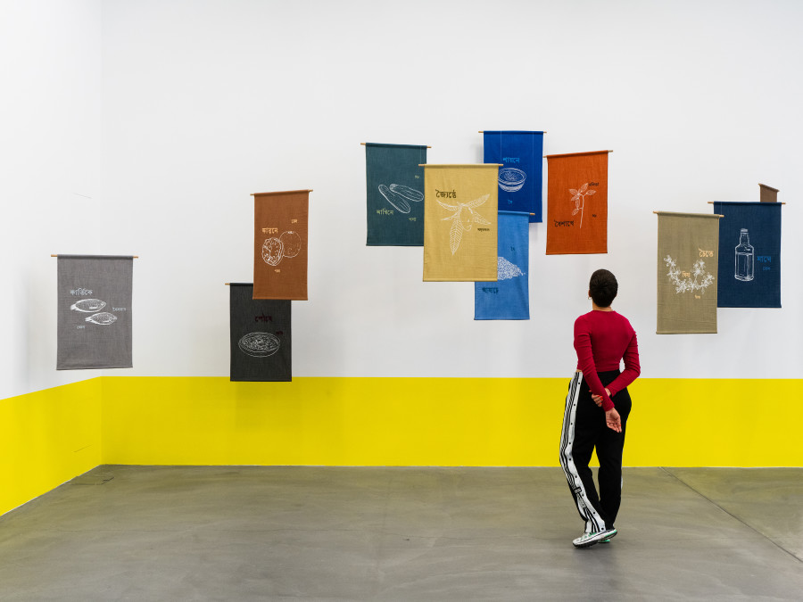 Munem Wasif, Song of Seasons – An Ecological Calendar, 2023 – Ongoing, Natural dye textile, drawing from photographs, silkscreen print, hand-stitched text with wooden and steel hanging system, Courtesy of Munem Wasif and Project 88. Installation view Migros Museum für Gegenwartskunst, Photo: Studio Stucky