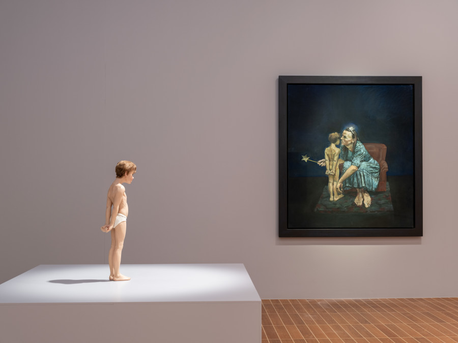 Exhibition view, Paula Rego, Power Games, Kunstmuseum Basel, 2024-2025. Pinocchio, Ron Mueck, 1996, Fiberglass, hair, pigments, 83.8 x 20 x 20 cm. The Collection of John & Amy Phelan. The Blue Fairy Whispers to Pinocchio, Paula Rego, 1995, 170 x 150 cm. © Paula Rego. All rights reserved 2024 / Bridgeman Images. Margarida Marinho. Photo credit: Max Ehrengruber & Jonas Schaffter.