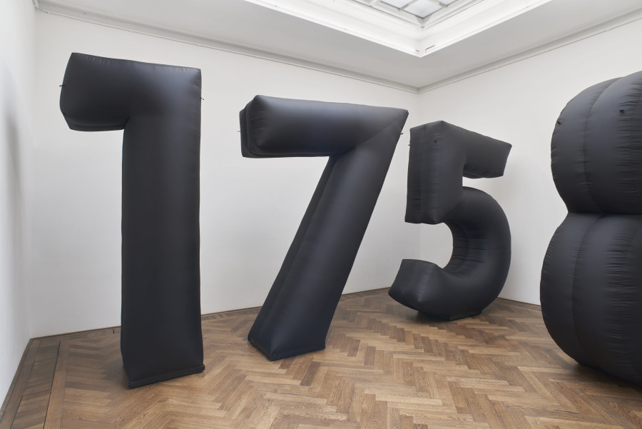 Ghislaine Leung, One Hundred Seventy-Five, 2024, installation view, in: Ghislaine Leung, Commitments, Kunsthalle Basel, 2024, photo: Philipp Hänger / Kunsthalle Basel. Score: A large black inflatable of the number of days the artist would work for her exhibition fee of 3.000,00 CHF according to Industria and a-n The Artists Information Company’s reported median wage in “Structurally F–cked” of 1.88 GBP per hour for an artist’s production of artworks and exhibition-making. The inflatable may be inflated for eight working hours daily, for a total of 175 days from the start of each exhibition period. All works courtesy the artist; Maxwell Graham, New York; and Cabinet, London.